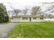 Charming single-story home with a well-manicured lawn and a paved driveway leading to an attached garage at 7144 Lockwood Ln, Indianapolis, IN 46217