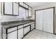 The kitchen features white cabinets, complementing white backsplash tiles, and neutral-colored countertops at 7144 Lockwood Ln, Indianapolis, IN 46217