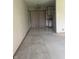 Open area leading to the kitchenette featuring tile flooring, and white cabinetry at 7144 Lockwood Ln, Indianapolis, IN 46217