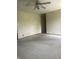 Spacious living room featuring neutral carpet and ceiling fan with natural light at 7144 Lockwood Ln, Indianapolis, IN 46217