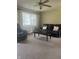 Comfortable living room with reclining sofa, neutral carpet, ceiling fan and large window at 7144 Lockwood Ln, Indianapolis, IN 46217