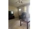 Cozy living room featuring plush chair, ceiling fan, neutral carpet, and a large window at 7144 Lockwood Ln, Indianapolis, IN 46217