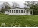 The home features a rear exterior with a row of windows overlooking the backyard at 7144 Lockwood Ln, Indianapolis, IN 46217