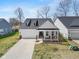 Aerial view of a charming two-story home with a well-kept front yard and long driveway at 7210 Covington St, Lebanon, IN 46052