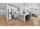 Modern kitchen with white cabinets, stainless steel appliances, and an island with seating at 7210 Covington St, Lebanon, IN 46052