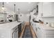Open kitchen with an island, stainless steel appliances, and views into the living area at 7210 Covington St, Lebanon, IN 46052