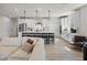 Open-concept kitchen and living area with island seating and stainless steel appliances at 7210 Covington St, Lebanon, IN 46052