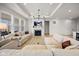 Bright living room with modern fireplace, white couches, and light hardwood flooring at 7210 Covington St, Lebanon, IN 46052