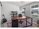 Well-lit home office featuring a large desk, shelving, and a view to the exterior at 7210 Covington St, Lebanon, IN 46052