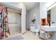 Bathroom showcasing shower with curtain, vanity, toilet, and grab bars at 7265 Derbyshire Dr, Cumberland, IN 46229
