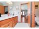 Bathroom featuring double sink vanity with cherry wood cabinets at 7265 Derbyshire Dr, Cumberland, IN 46229
