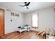bedroom featuring a ceiling fan, wood floors, and a small bed with a blue blanket at 7265 Derbyshire Dr, Cumberland, IN 46229