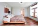 Bright bedroom featuring wood floors, neutral walls, and a decorative throw at 7265 Derbyshire Dr, Cumberland, IN 46229