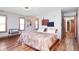 Comfortable bedroom featuring wood floors, neutral walls, and a decorative throw at 7265 Derbyshire Dr, Cumberland, IN 46229