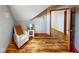 Cozy room with sloped ceiling, wood floors, and comfortable reading nook near an open doorway at 7265 Derbyshire Dr, Cumberland, IN 46229