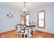 Dining room showcasing table with four chairs, wood floors, and natural lighting at 7265 Derbyshire Dr, Cumberland, IN 46229