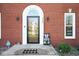 Close-up view of the front door showing sidelights and a 'Welcome' mat at 7265 Derbyshire Dr, Cumberland, IN 46229