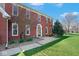 Traditional two-story brick home with a covered front entrance and landscaped front yard at 7265 Derbyshire Dr, Cumberland, IN 46229