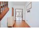Welcoming hallway features hardwood floors and an entrance to a living area with an accent wall at 7265 Derbyshire Dr, Cumberland, IN 46229