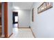 Hallway with gray walls, a door, and a framed picture hanging on the wall at 7265 Derbyshire Dr, Cumberland, IN 46229