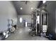 Home gym equipped with exercise machines, weights, mirrors, and rubber flooring at 7265 Derbyshire Dr, Cumberland, IN 46229