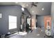 Bright home gym with weight training system, free weights, rubber floor, and ceiling fan at 7265 Derbyshire Dr, Cumberland, IN 46229