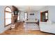 Comfortable living room features brick fireplace, modern lighting, and hardwood floors at 7265 Derbyshire Dr, Cumberland, IN 46229