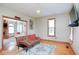 Inviting living room featuring hardwood floors, ample natural light, and doorway to the dining area with fireplace at 7265 Derbyshire Dr, Cumberland, IN 46229