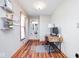 Small office area with wooden desk, shelving, and wood floors at 7265 Derbyshire Dr, Cumberland, IN 46229