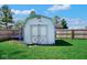 Utility shed in the backyard with a wooden door and a wooden fence surrounding the property at 7265 Derbyshire Dr, Cumberland, IN 46229