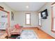 Comfortable sitting room with plenty of sunlight, hardwood floors, and decorative rug at 7265 Derbyshire Dr, Cumberland, IN 46229