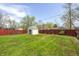 Spacious backyard with a storage shed, lush green grass and a privacy fence at 739 Laurel Ln, Fortville, IN 46040