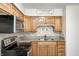 Well-maintained kitchen with oak cabinets, modern appliances, and tile backsplash at 739 Laurel Ln, Fortville, IN 46040
