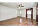Open-concept living area with neutral walls, wood-look floors, and a ceiling fan at 739 Laurel Ln, Fortville, IN 46040