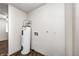 A utility room with water heater, light brown floor, and white walls at 739 Laurel Ln, Fortville, IN 46040
