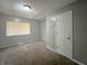 This is a gray bedroom with carpet and a window at 7606 Miracle Rd, Indianapolis, IN 46237