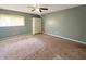 Comfortable bedroom with neutral carpet, a ceiling fan, and a built in wardrobe at 7606 Miracle Rd, Indianapolis, IN 46237
