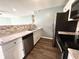 Modern kitchen featuring stainless steel appliances, granite countertops, and white cabinetry at 7606 Miracle Rd, Indianapolis, IN 46237