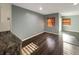Spacious open-plan living room with hardwood floors, neutral walls, and a sliding glass door at 7606 Miracle Rd, Indianapolis, IN 46237