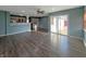 Inviting living space with hardwood floors, an adjacent kitchen, and a glass sliding door at 7606 Miracle Rd, Indianapolis, IN 46237