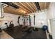 Finished basement gym with workout equipment, rubber flooring, and exposed ceiling at 8160 Shaldon Ct, Zionsville, IN 46077