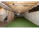 Unfinished basement with exposed ceiling, concrete walls, and green turf area at 8160 Shaldon Ct, Zionsville, IN 46077