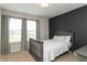 Bright bedroom with modern decor with a black accent wall and neutral-colored carpet at 8160 Shaldon Ct, Zionsville, IN 46077