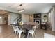 Dining area open to the living room and kitchen, featuring an oversized table and modern light fixture at 8160 Shaldon Ct, Zionsville, IN 46077