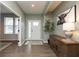 Welcoming entryway with wood floors, neutral walls, stylish console, and view into living room at 8160 Shaldon Ct, Zionsville, IN 46077