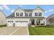 Charming two-story home with a three-car garage, black shutters, and a well-manicured front yard at 8160 Shaldon Ct, Zionsville, IN 46077