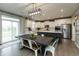 Bright kitchen with white cabinets, a central island with seating, and stainless steel appliances at 8160 Shaldon Ct, Zionsville, IN 46077