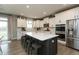 Bright kitchen featuring a large island, stainless steel appliances, and white cabinets at 8160 Shaldon Ct, Zionsville, IN 46077
