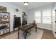 Home office with natural light, hardwood floors, and well-appointed desk at 8160 Shaldon Ct, Zionsville, IN 46077