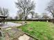 Expansive backyard with a fire pit and mature trees at 8616 Old Dominion Ct, Indianapolis, IN 46231